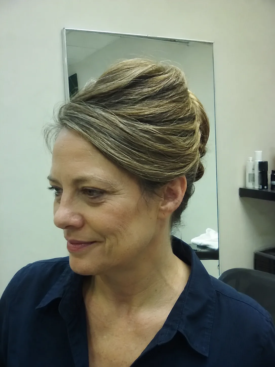 Pearl pin wedding guest updo with soft twisted low bun