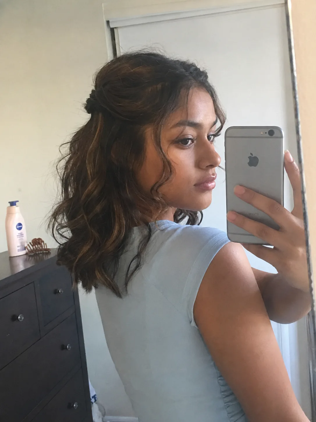 Prom hairstyles for medium length hair with half-up curls and pinned back detail
