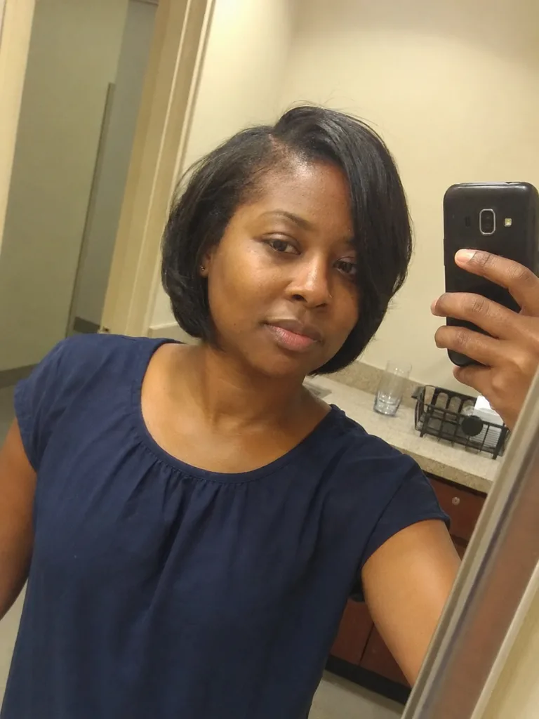 Short side-part bob haircut for women with smooth rounded shape and soft face framing.