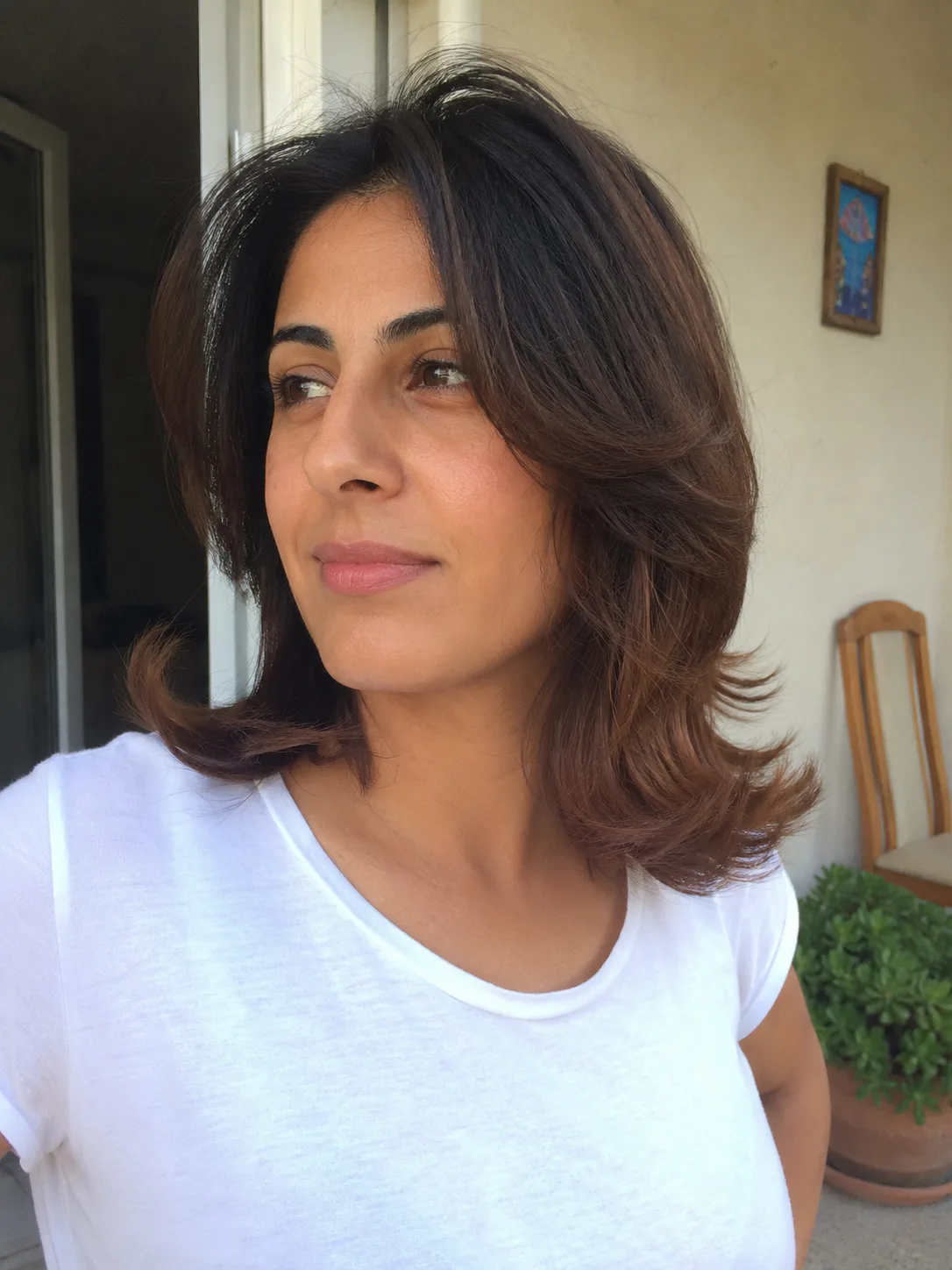 Side part blowout hairstyle with lifted roots and soft layered volume