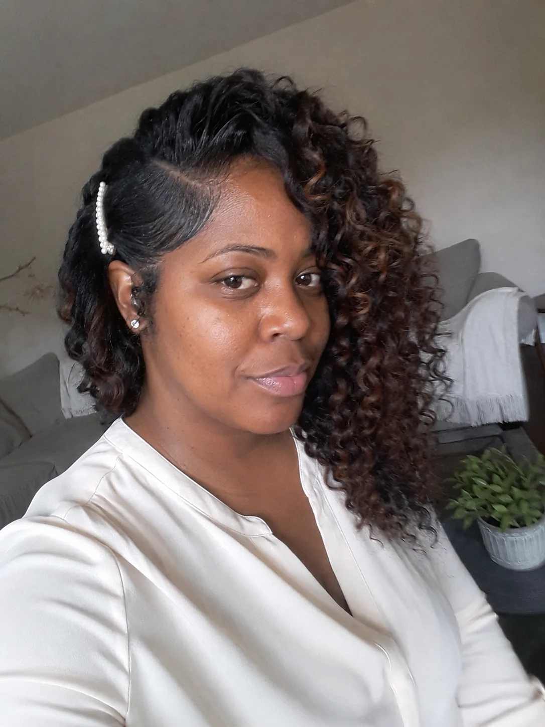 Side profile salon shot of dark wavy hair featuring a simple accent side braid pinned above the ear