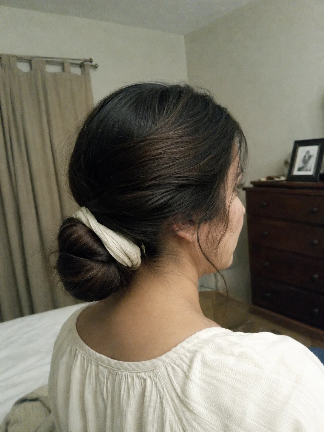 Side profile view of an outdoor festival updo pinned securely at primary stress points