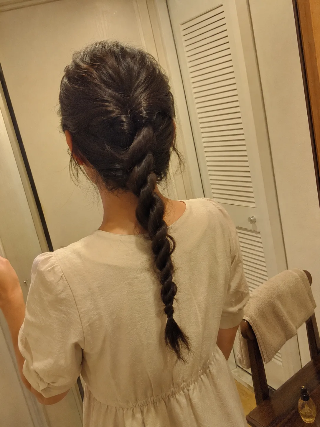 Side view of a messy, textured fishtail braid showing natural hold without heavy products