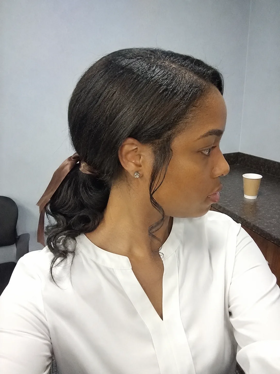 Sleek center-parted medium-length bob showing a clean, finished perimeter
