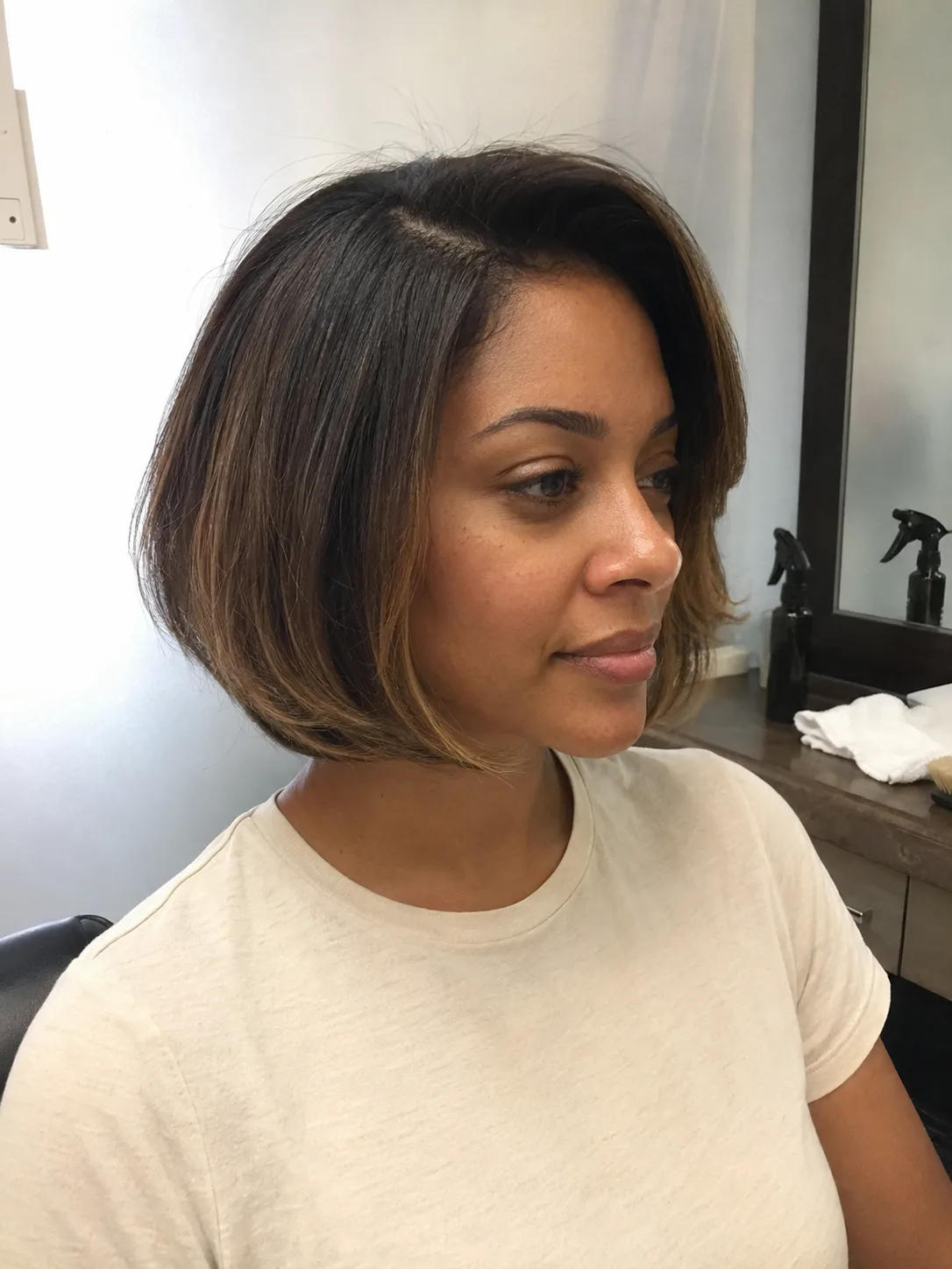 Soft blowout hairstyle with natural layered movement and side part