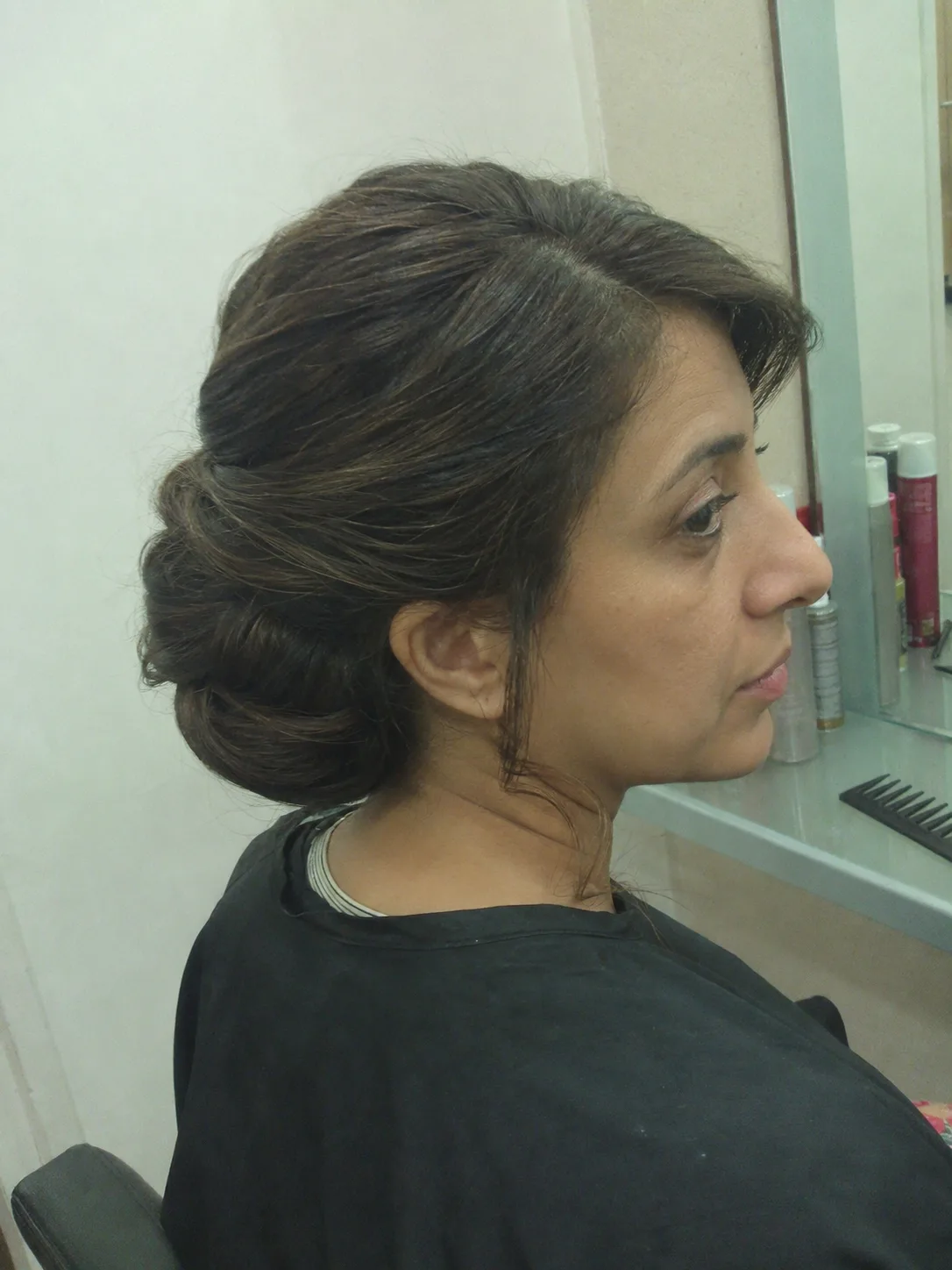 Soft curled bob wedding guest hairstyle with side part and flipped ends