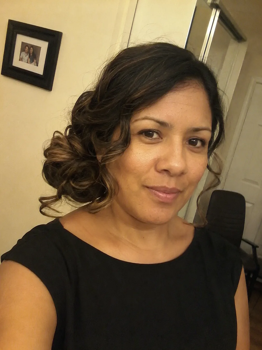 Soft low chignon bridesmaid hairstyle with loose tendrils