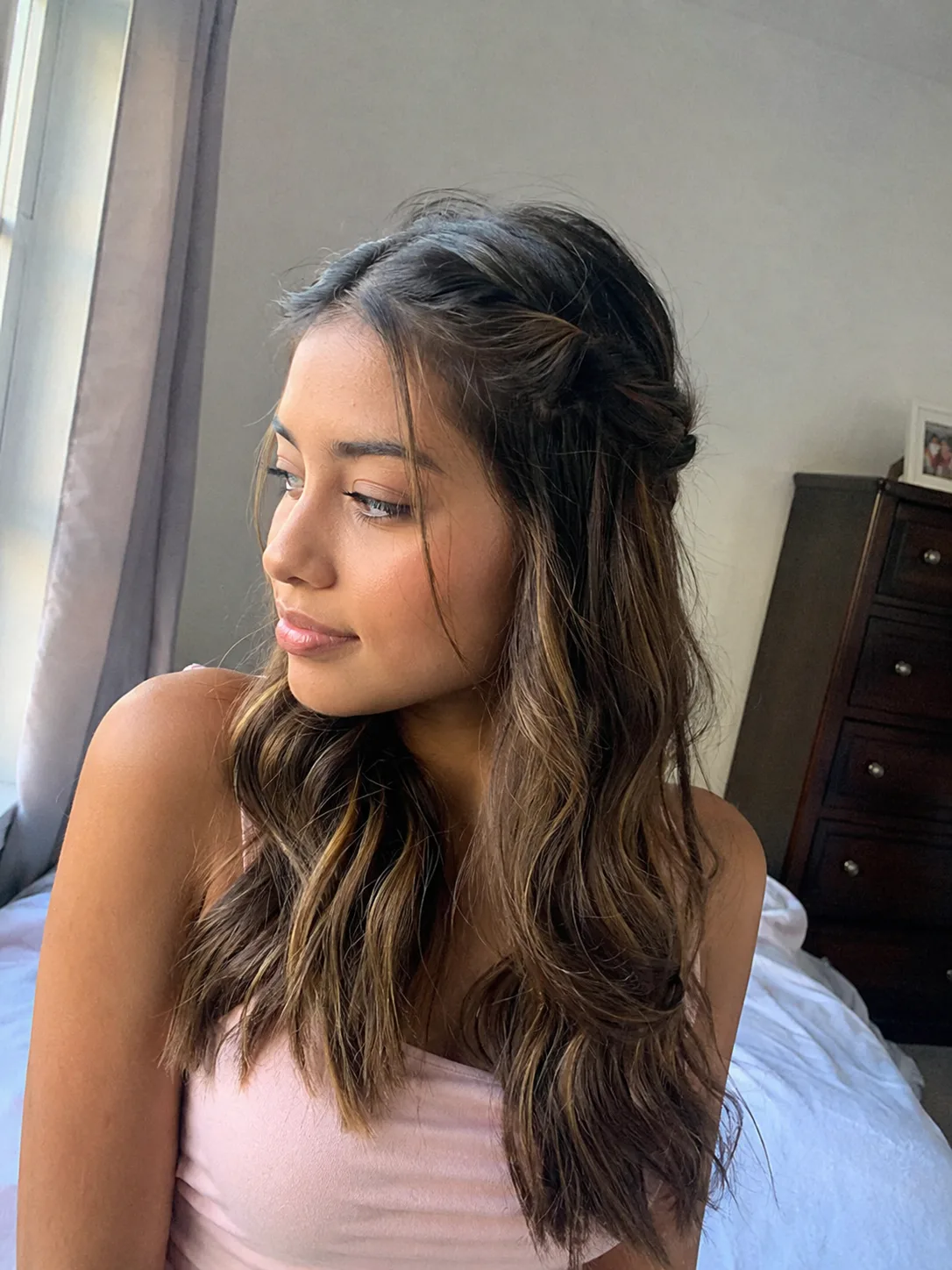 Soft low ponytail prom hairstyle with curled ends and relaxed volume