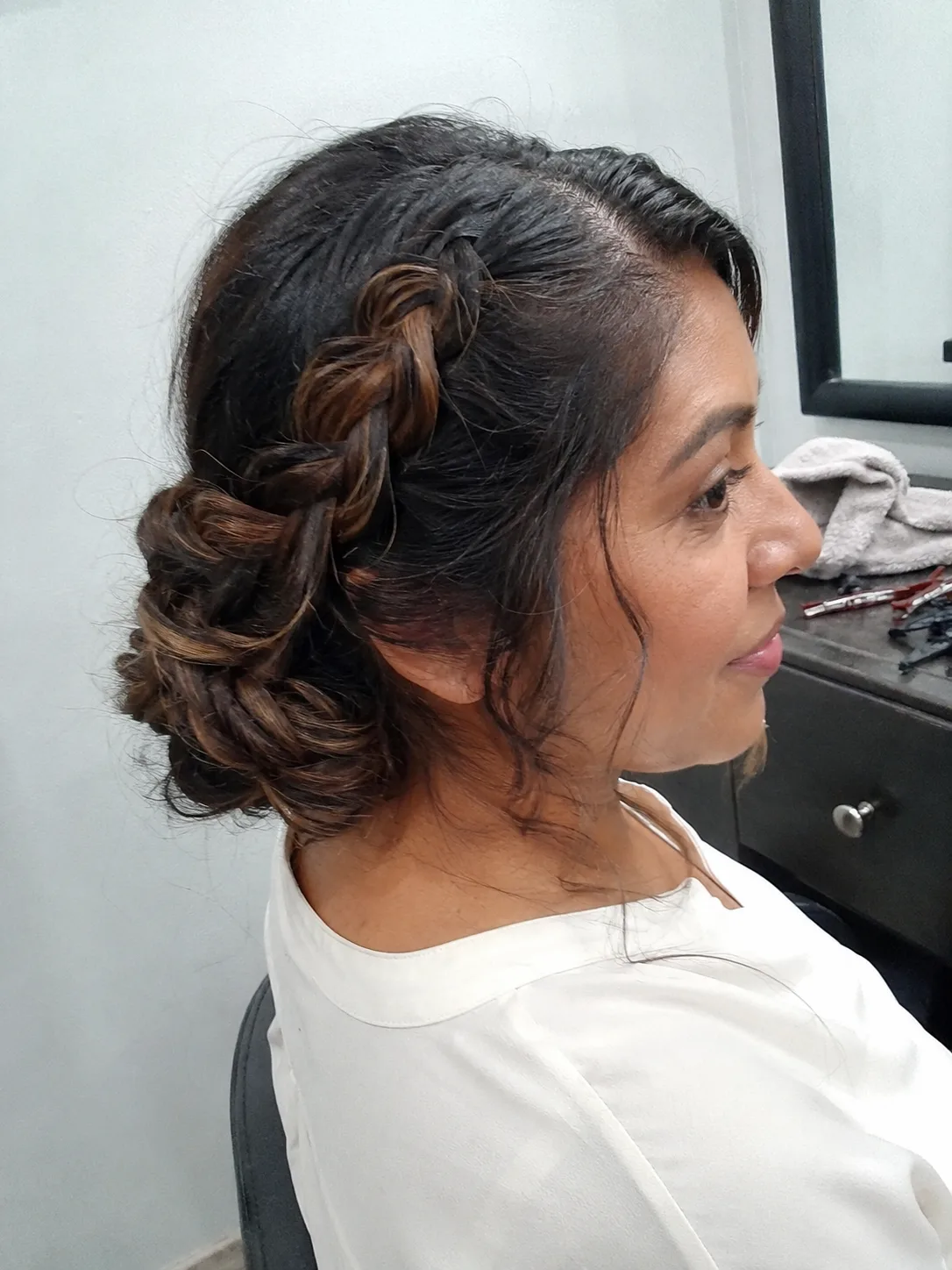 Soft romantic bridesmaid updo with loose face-framing curls
