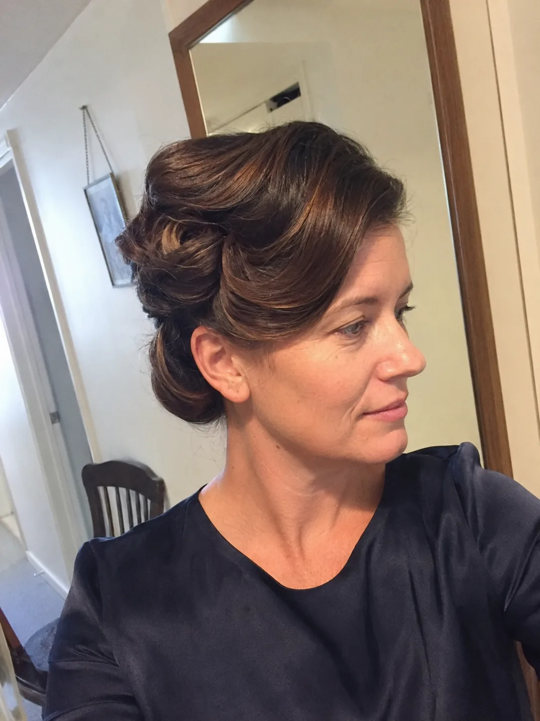 Soft side swept bridesmaid bun with loose curls