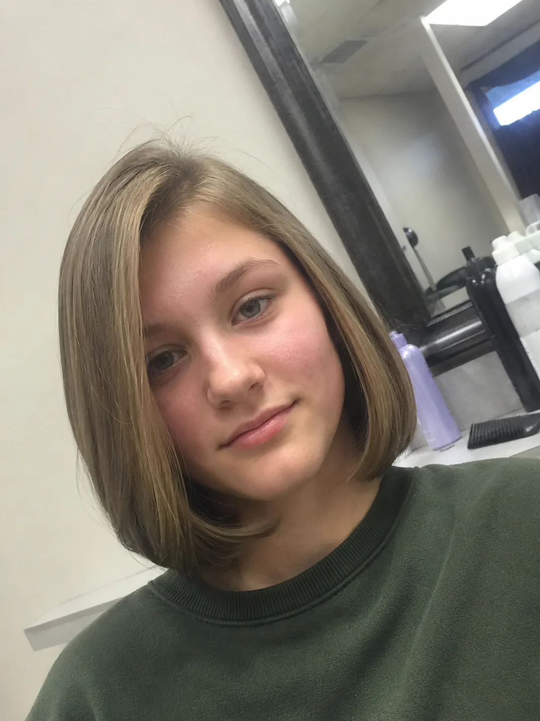 Teen girl with half up half down wavy hairstyle for school with soft curls and face framing pieces
