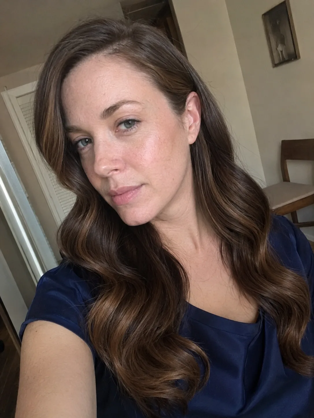 Textured half up wedding guest hairstyle with loose wavy length