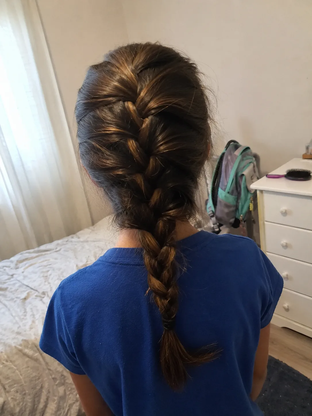 Thick school hair styled in a neat french braid for easy everyday maintenance