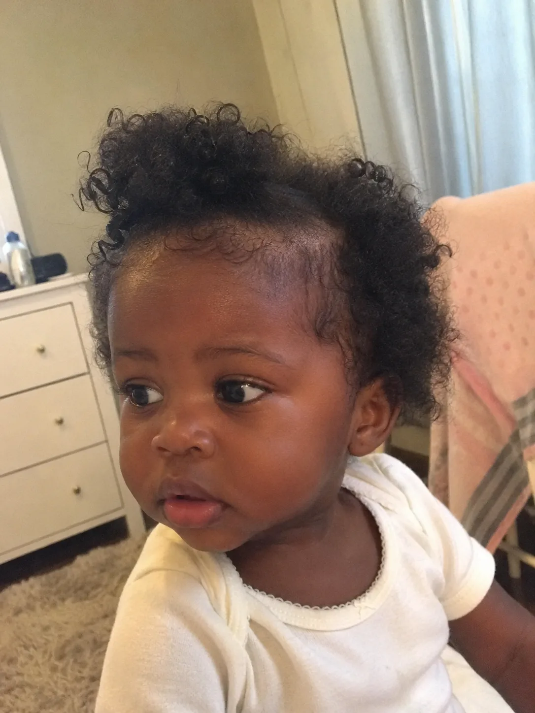 Transitional curl pattern on an infant showing tighter roots and looser ends