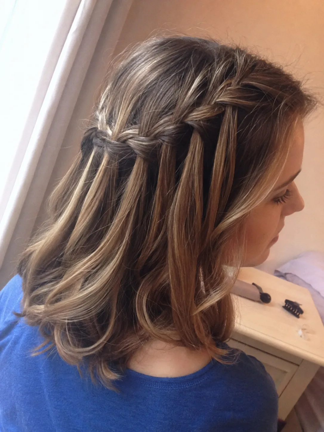 Waterfall braid prom hairstyle on medium highlighted hair