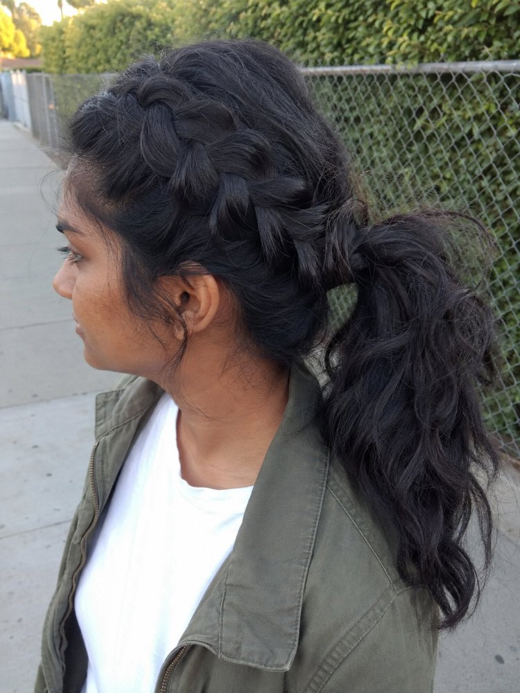 dark brown appears long extending The hair is dark brown and is long, extending down to the middle of the back