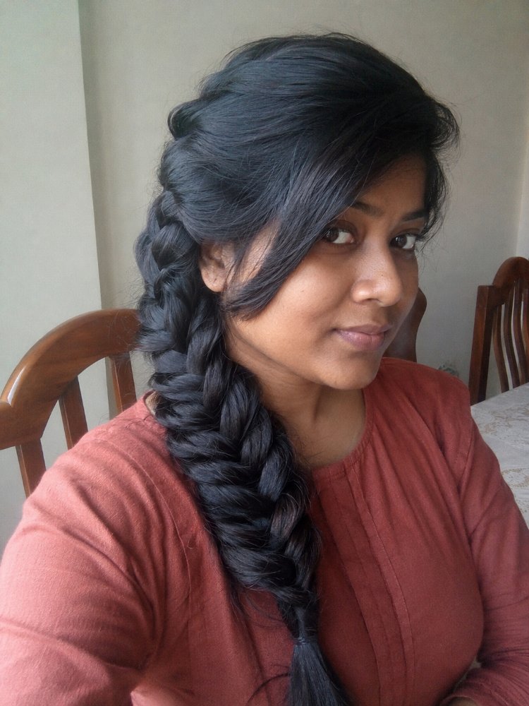 The hair is dark brown or black in color, a single, uniform shade with subtle highlights