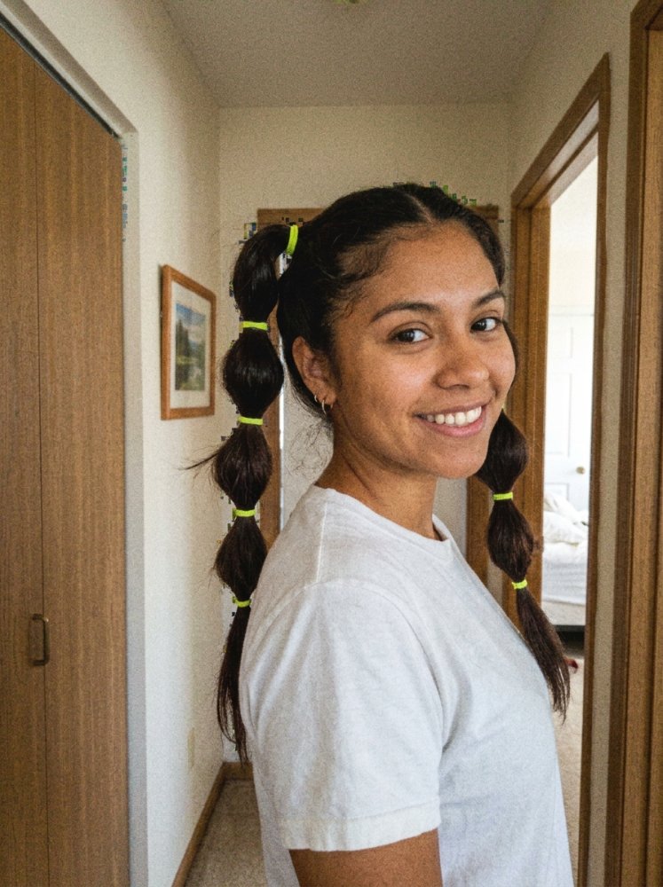 The hair is dark brown in color and is long, extending down the back
