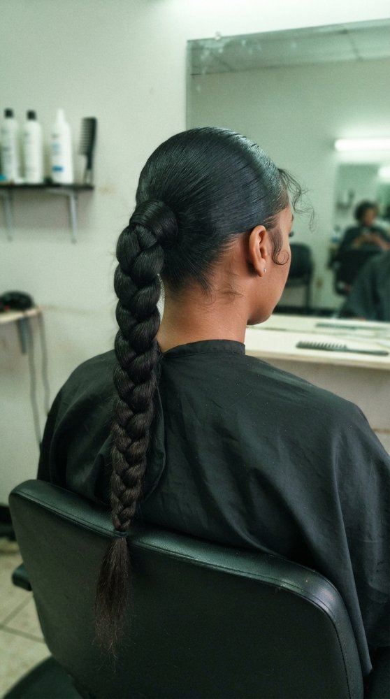 The hair is dark brown in color and is long, extending down the back