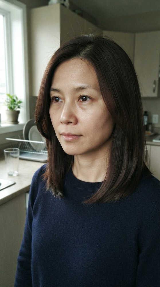 The hair is dark brown in color, falling just below the shoulders in length
