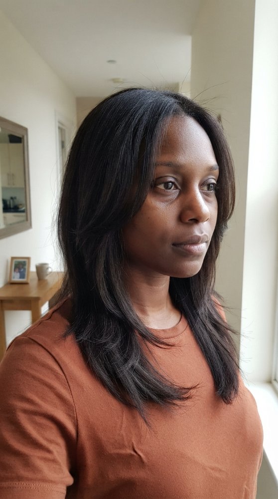 Dark brown shoulder-length hair with smooth texture.
