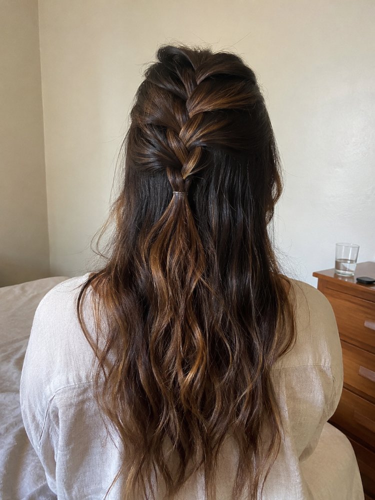 The hair is a dark brown color with subtle highlights of lighter brown, creating dimension and depth