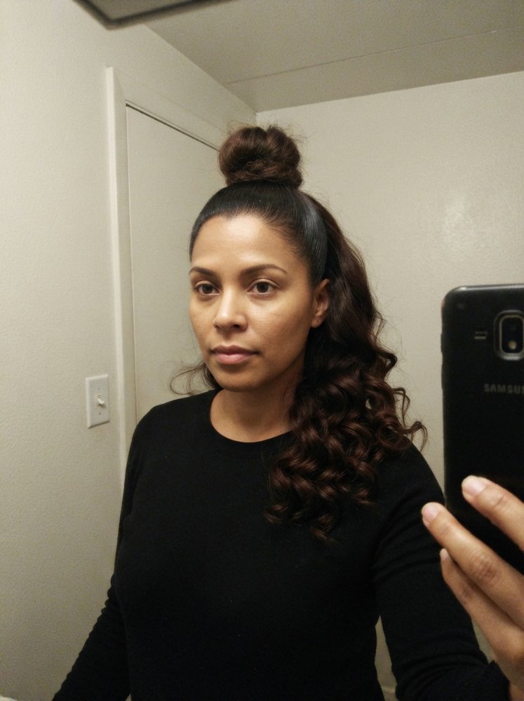 Dark brown hair with loose spiral curls and sleek top