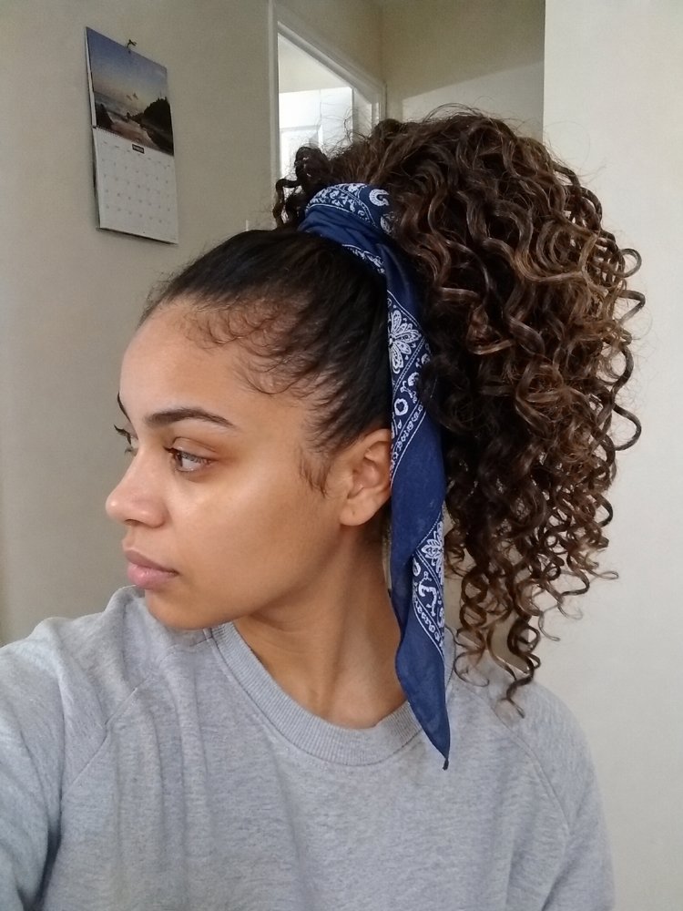 dark brown subtle highlights appearing The hair is dark brown with subtle highlights, appearing to have a natural, multi