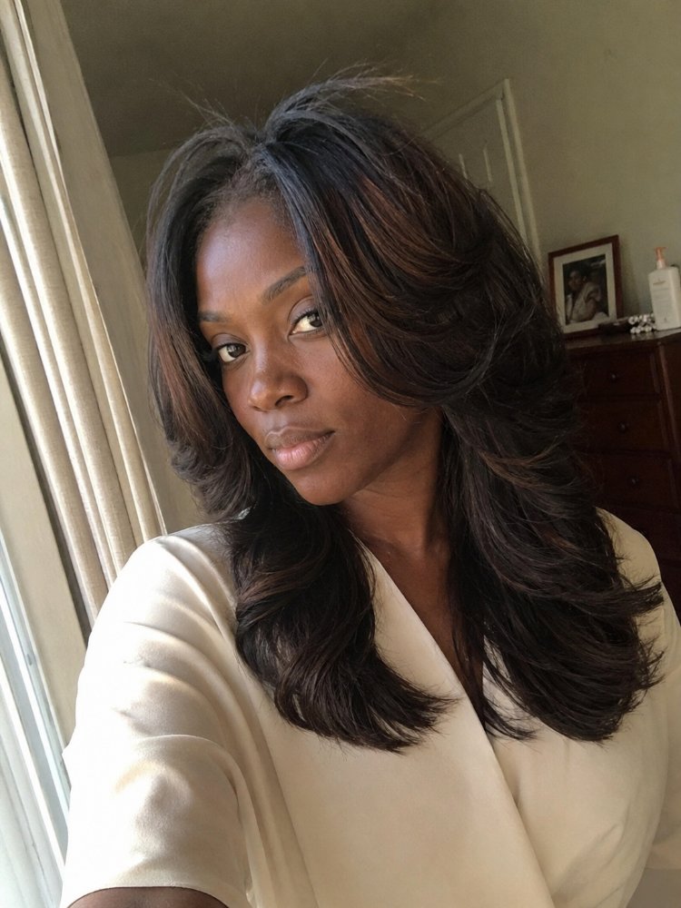 dark brown subtle highlights lighter The hair is dark brown with subtle highlights of lighter brown, adding dimension and texture