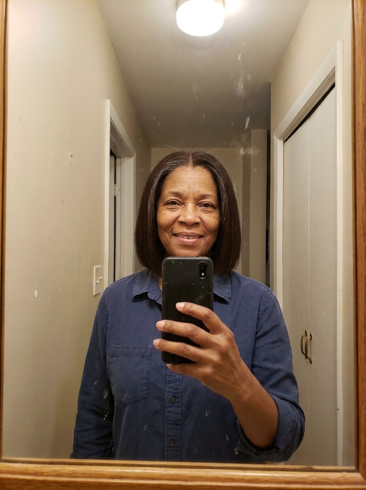 Straight shoulder-length brunette bob with subtle gray strands