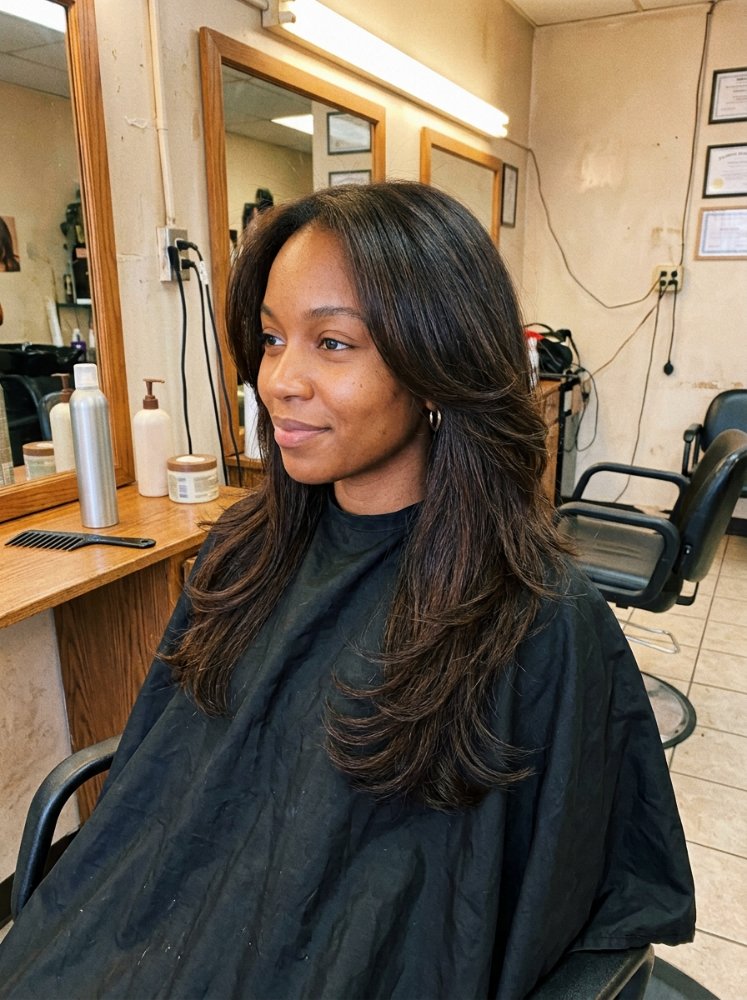 Long straight brunette hair with side-swept face-framing layers