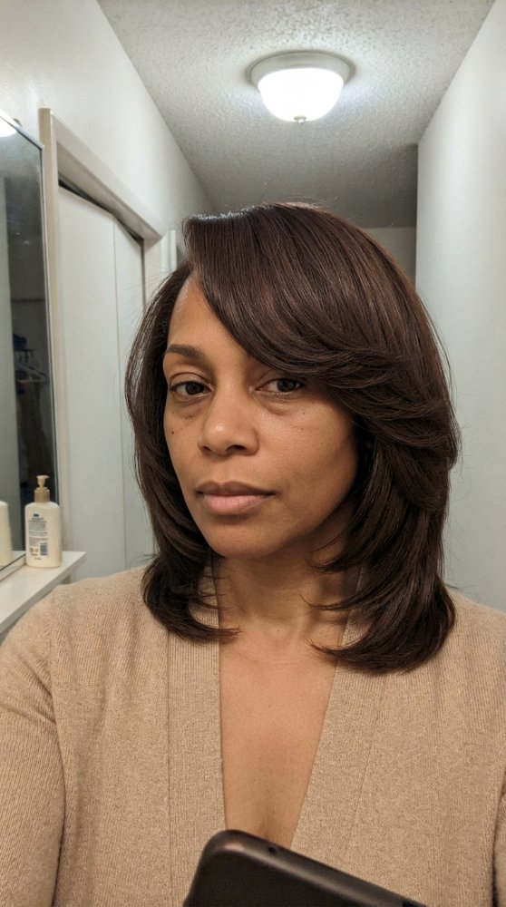 The hair is dark brown with a subtle, multi