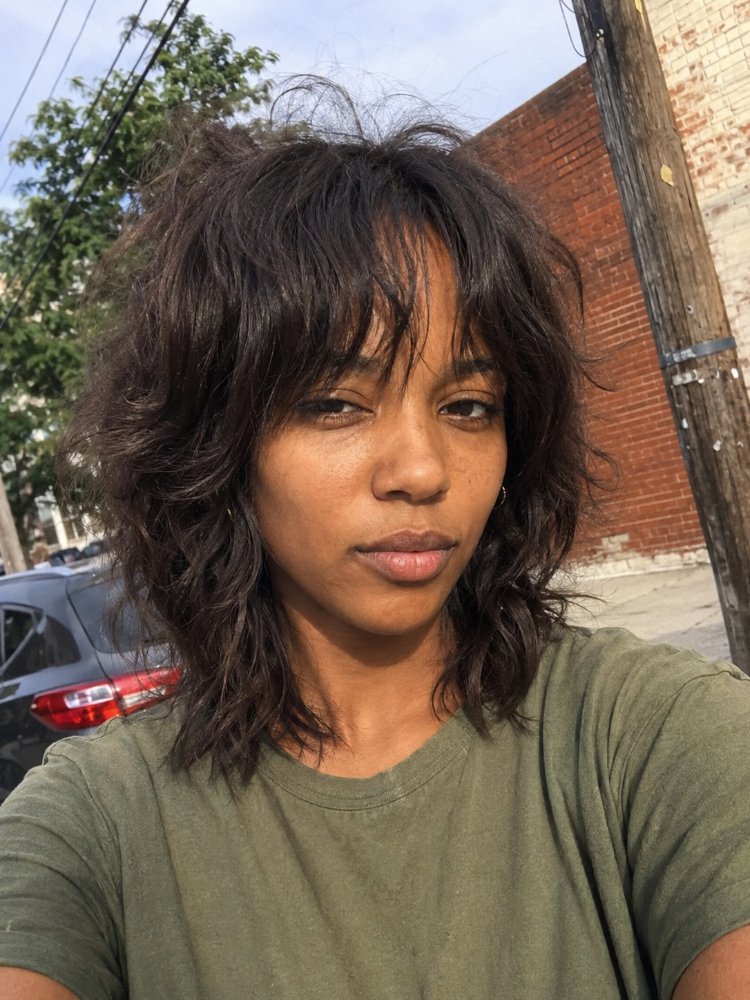 dark brown subtle natural looking dimension The hair is dark brown with a subtle, natural-looking dimension