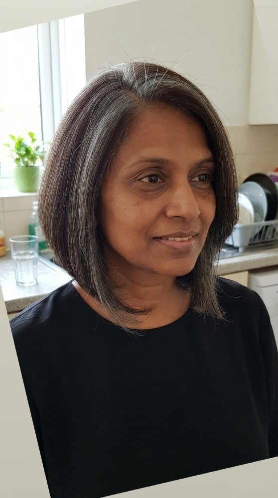 Short dark brown layered bob with natural gray roots