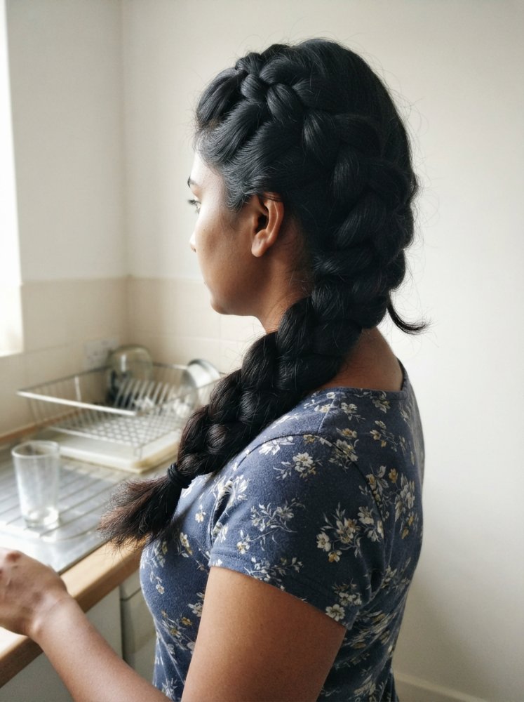 The hair is dark in color and is long, extending down the back