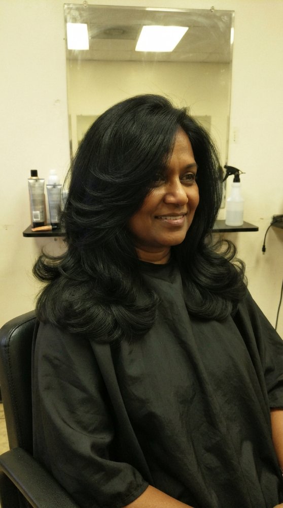 Dark shoulder-length hair with smooth texture and subtle layers.