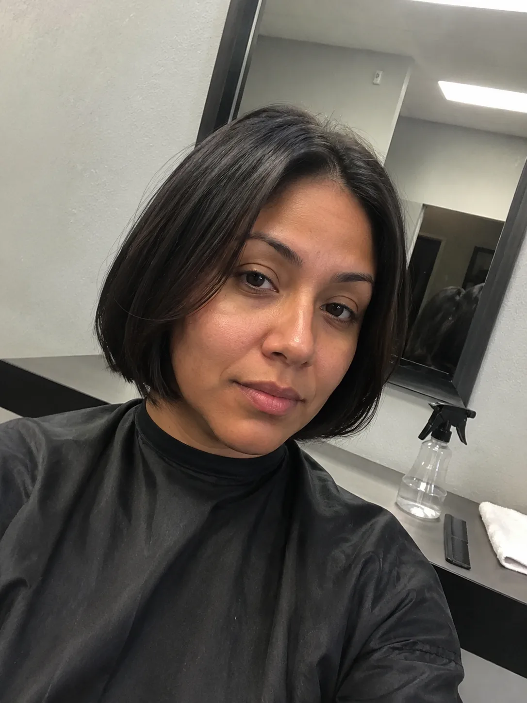 layered pixie bob haircut for women in salon consultation