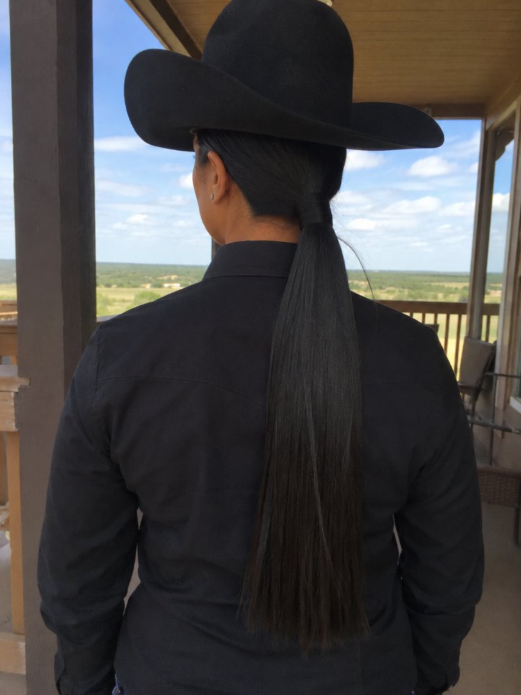 long straight dark color styled The hair is long, straight, and dark in color. It is styled in a low ponytail that extends down the back, reaching a considerable length. The hair appears to be smooth and sleek
