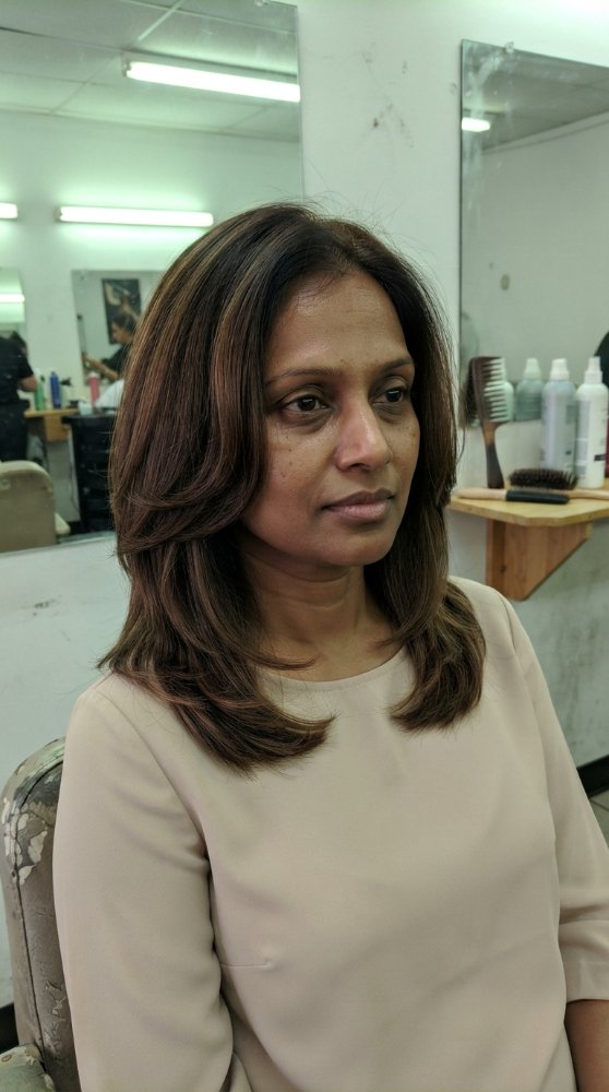 The hair is a medium to dark brown color with subtle dimension and a slightly glossy finish