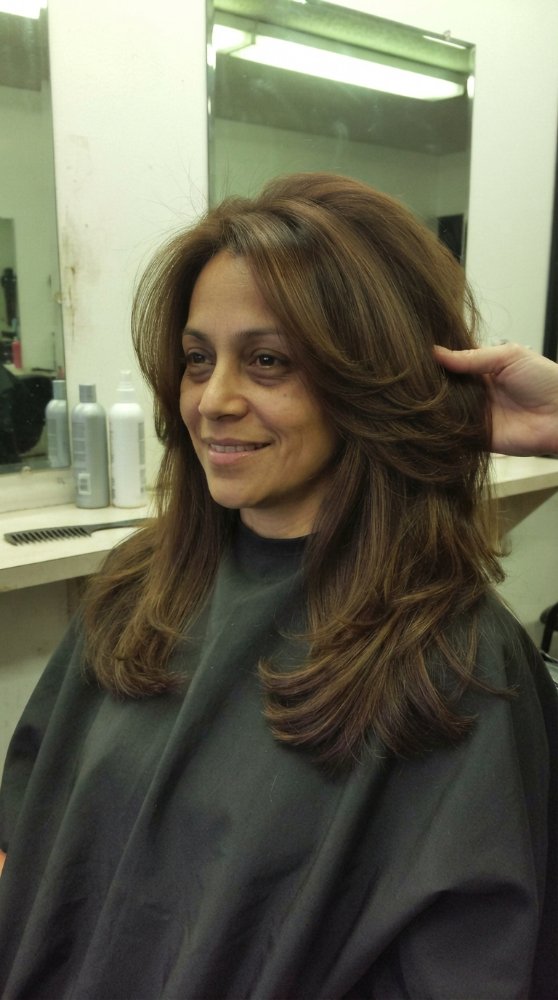 The hair is a medium to dark brown color with subtle highlights, adding dimension and texture.