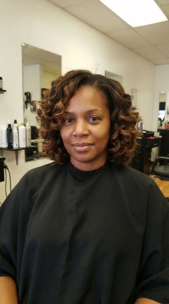 The hair is a medium to dark brown color with subtle highlights, adding dimension and texture