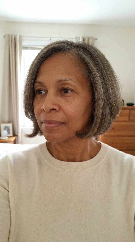 The hair is a medium-length, straight cut that falls just below the chin