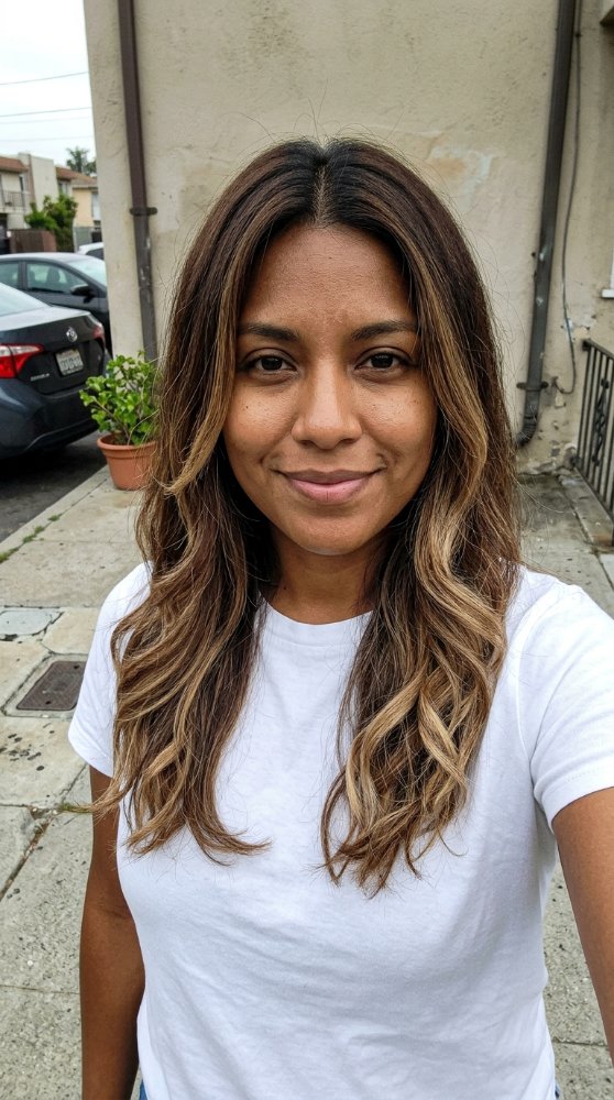 The hair is a medium to long length with a wavy texture