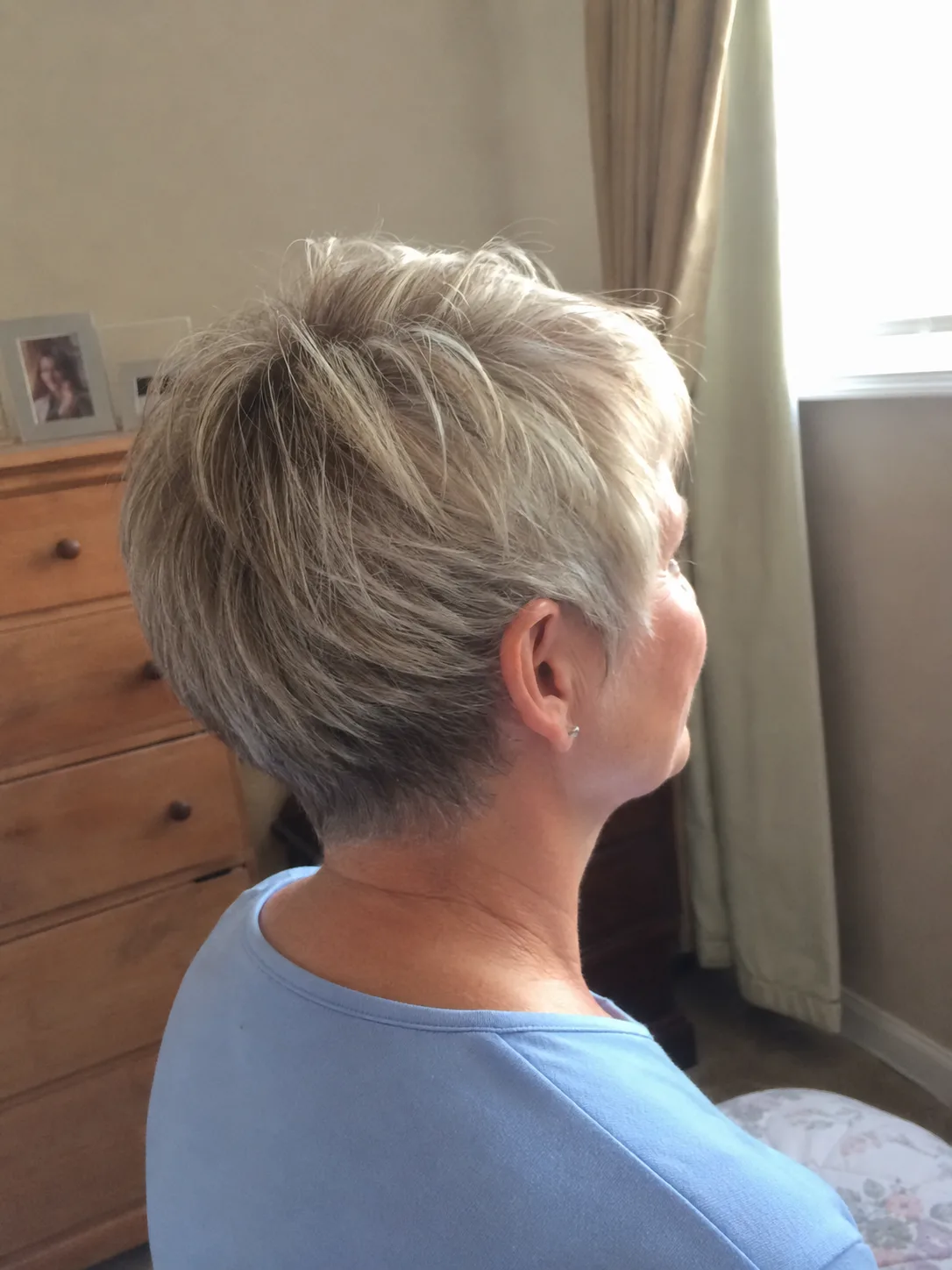 Pixie cut with soft waves and piecey textured top for effortless short hair look