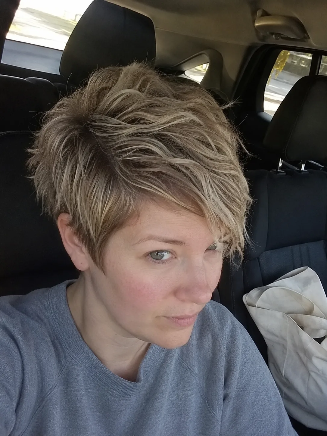 Classic short pixie haircut with blunt fringe bangs and smooth polished finish