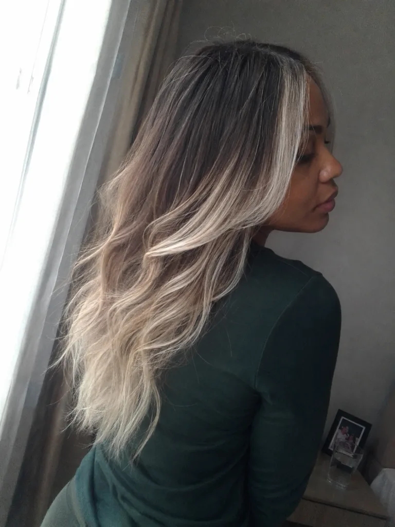 Platinum blonde short crop with soft waves and wispy bangs for modern short style.