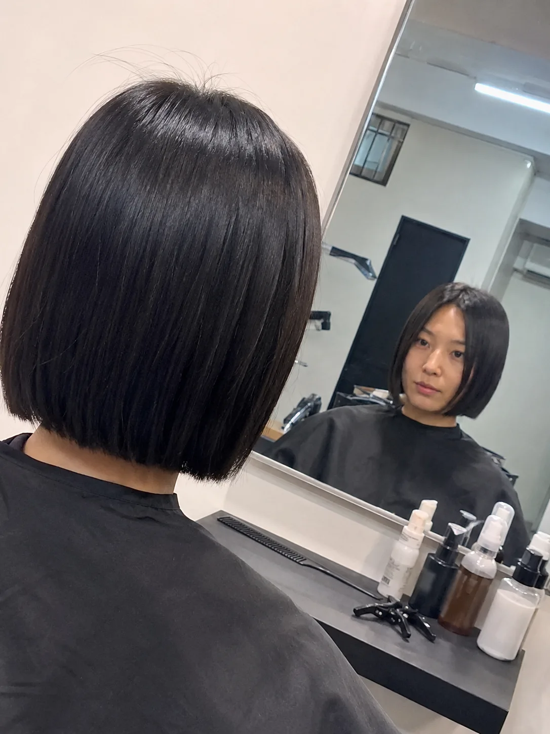 short Korean bob with clean blunt perimeter and soft jawline shape