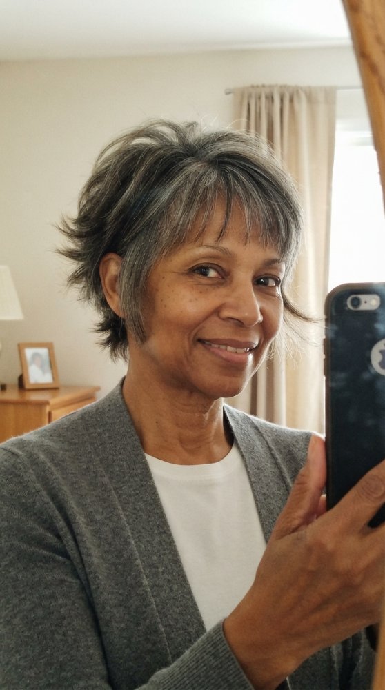 The hair is short in length, with a choppy texture and a layered cut style that adds dimension