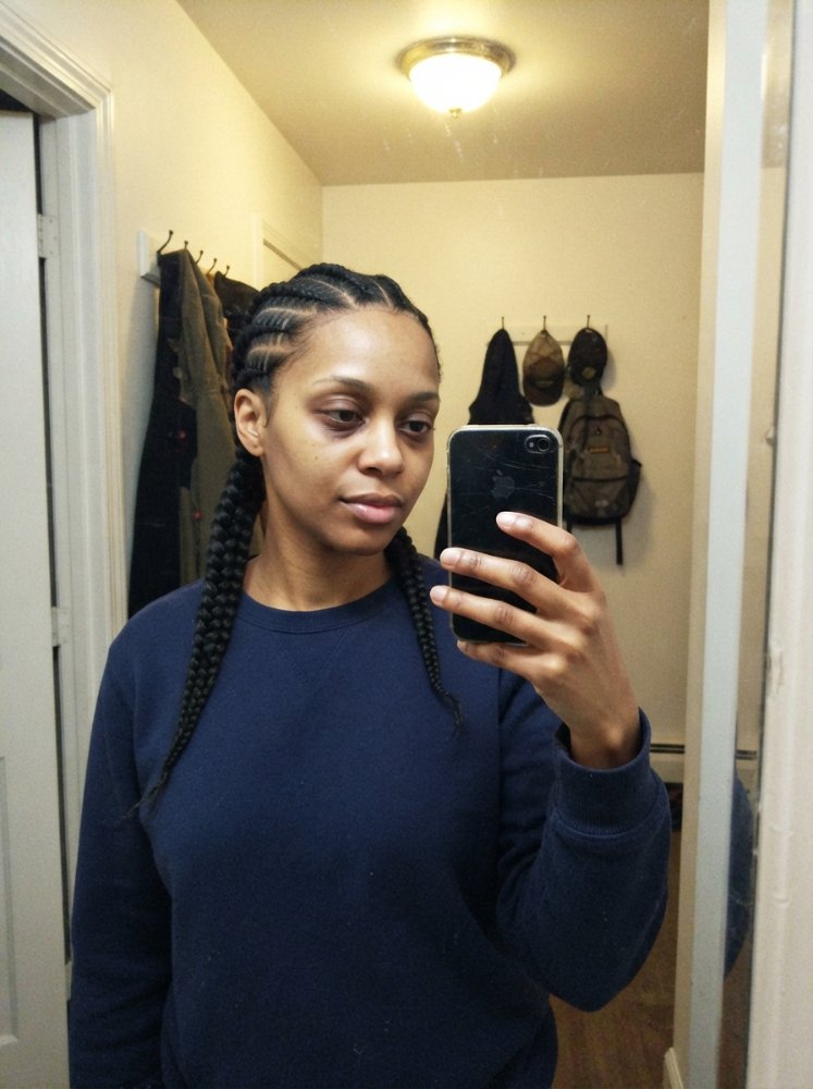 Woman taking mirror selfie hairstyle featuring layered detail and a flattering shape
