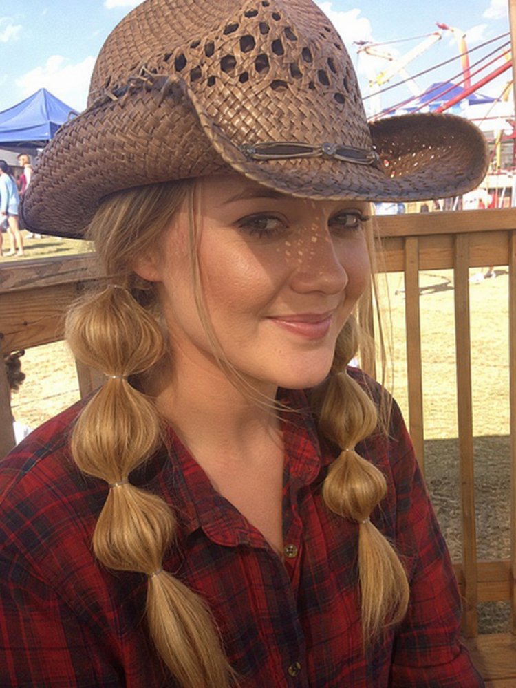 visible blonde light golden hue blonde with a light golden hue, styled in two bubble braids that fall down the front. The braids have a smooth texture and appear to be of medium length